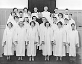 Zwingli Church confirmation class, 1955. Front row, l-r: Nancy Root, ??, Frances Gould, Joyce Zentner, Pauline Disch, ??. Row 2: ??, Gloria Lehnherr, Shirley Woodruff, Anna Marie Marty, Ernest Gempeler, Norman Crouch.  Row 3: Carol Taylor, Gordon Zimmerman, William Hefty, Rev. Achtemeier, Virginia Studer, Gail Wittenwyler, John Ponyiscanyi.  Back row: Joanne Grossen, Rosanda Richards, Armin Daubert, Steven Boyum, William Escher, James Zweifel.